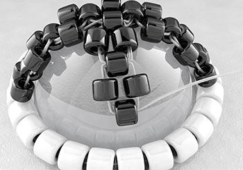Threading on a new set of three black beads 